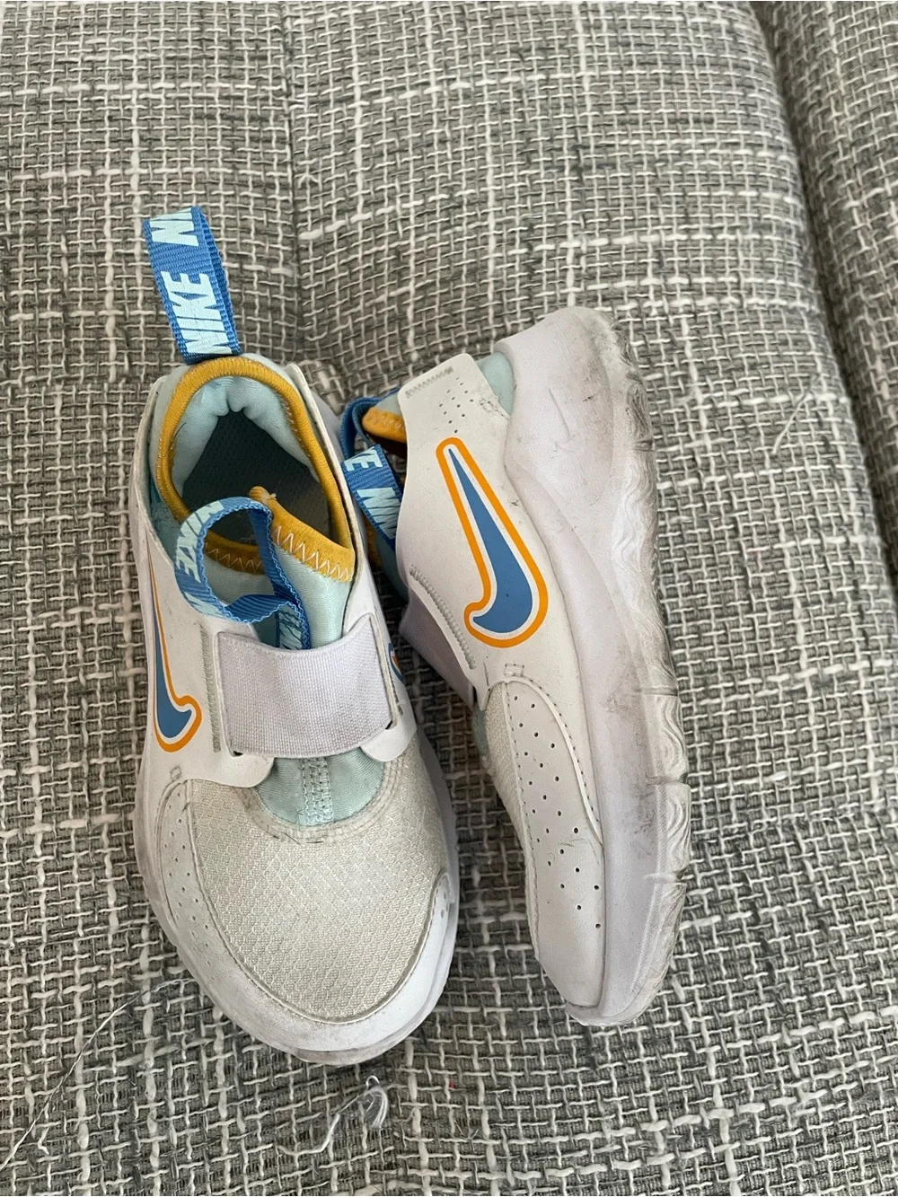 Nike Kids White Sneakers with Blue and Yellow Accents